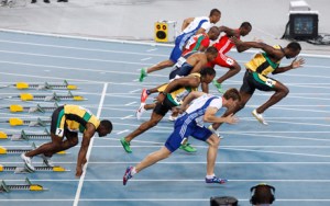 Usain Bolt of Jamaica (R) makes a false start as Nesta Carter of Jamaica stays in the blocks in the men's 100 metres final at the IAAF World Championships in Daegu August 28, 2011. Bolt false started and was disqualified from the world athletics championships 100 metres final on Sunday. REUTERS/Kim Kyung-Hoon (SOUTH KOREA - Tags: SPORT ATHLETICS IMAGE OF THE DAY TOP PICTURE)